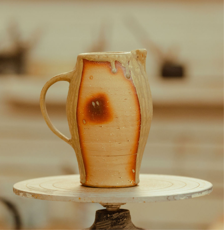 A ceramic pot on a spinning wheel as part of Remy Pajaczkowski-Russell's exhibition Moments of the Bay